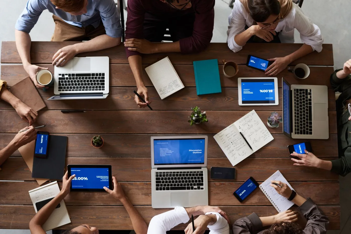 Digital Marketing Strategy in Mysore — overhead view of collaborative planning with laptops and notebooks